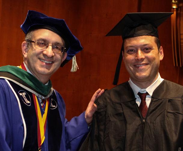 Joseph Reich of Brooklyn, N.Y. (right) shakes hands with Dr. Alan Kadish, president and CEO of the Touro College and University System, at the Lander College commencement exercises at Avery Fisher Hall. Reich was named the 2013 valedictorian of the men’s division of the Lander College of Arts & Sciences in Flatbush.