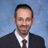 Headshot of Rabbi Moshe Barides smiling.