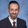 Headshot of Rabbi Moshe Barides smiling.