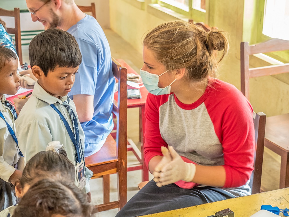 An LAS volunteer talks to a Nepalese child about basic health care. More than twelve undergraduate students from Touro volunteered for a medical mission to Nepal in August. 