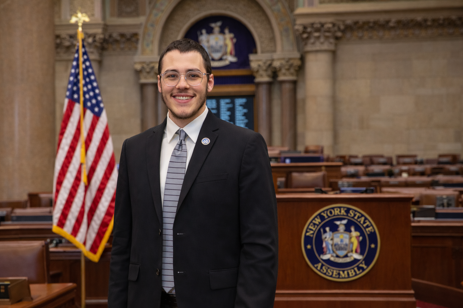 Yehoshuah Rybstein, Lander College of Arts and Sciences, part-time student and legislative director for New York State Assemblyman Lester Chang, poses for a picture on the floor of the New York State Assembly.